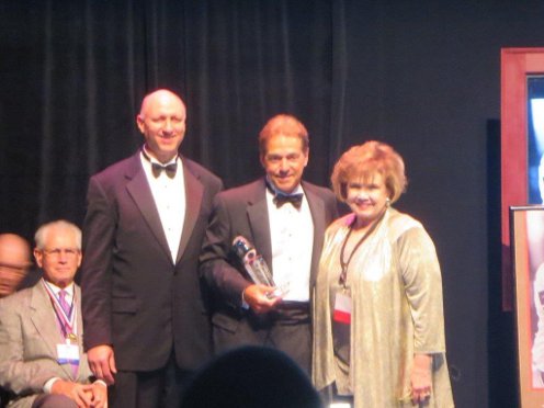 Dave Gyor, President of the BCSG and Dr Kay Collier McLaughlin with Blanton Collier Award winner Coach Nick Saban